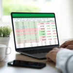 Founder reviewing startup booted financial modeling spreadsheet