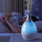 humidifier for bedroom placed on nightstand releasing mist